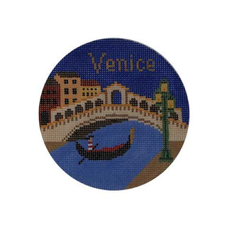 Round needlepoint coaster with a Venice scene featuring a gondola and bridge.